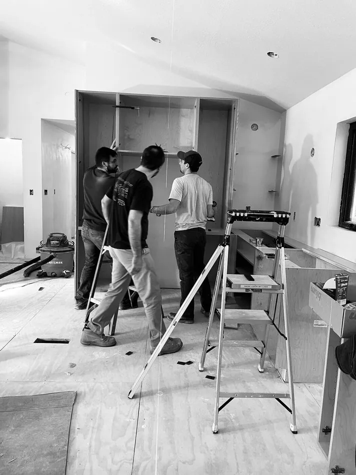 Crew and surveyor laying out a renovated apartment
